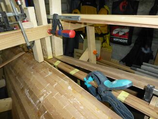 Stakes, tape and clamps hold the strips in place